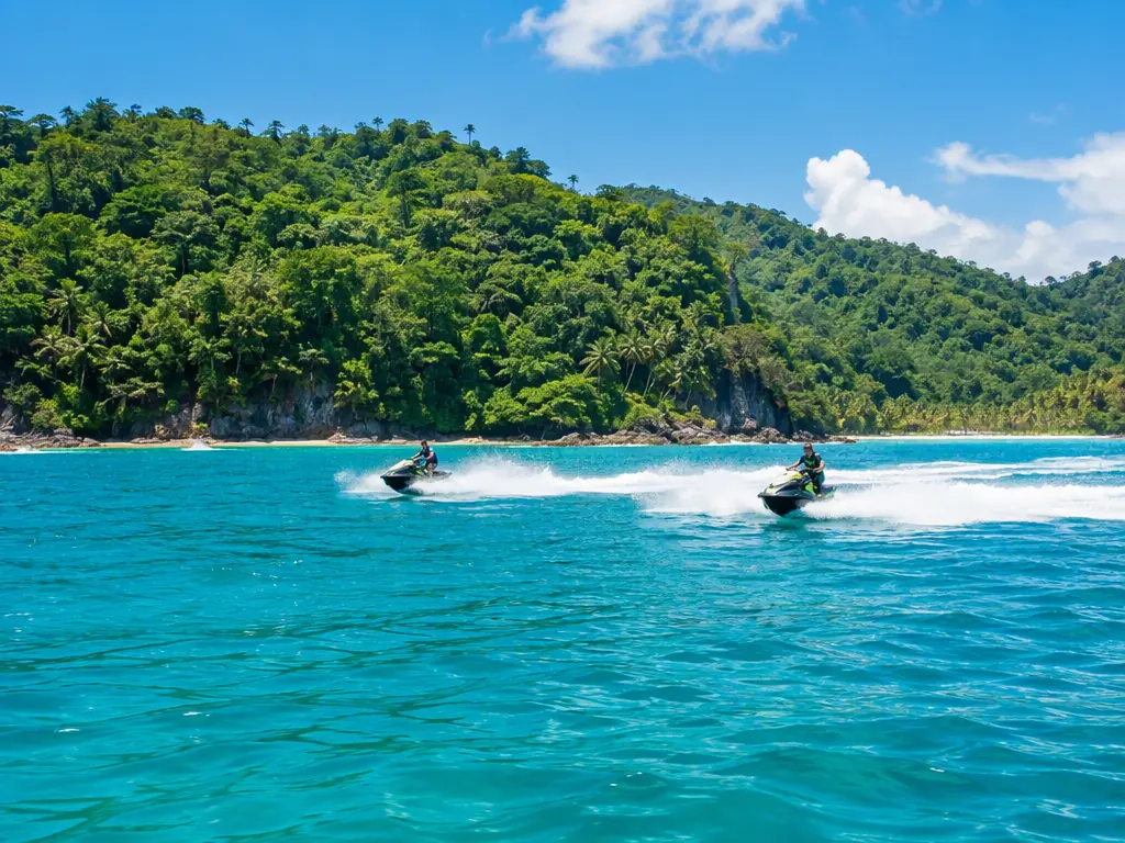 Two jet skis speeding across turquoise water off the Costa Rica coast